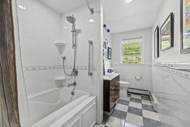 full bathroom featuring tile patterned floors, vanity, tile walls, tub / shower combination, and a wainscoted wall