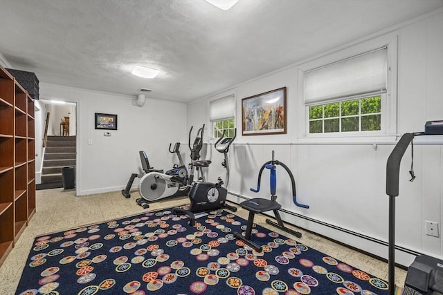exercise room with a decorative wall and baseboards
