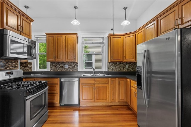 38 Torrey St, Boston, MA 02124 - kitchen featuring stainless steel appliances, a sink, dark countertops, wood finished floors, and backsplash