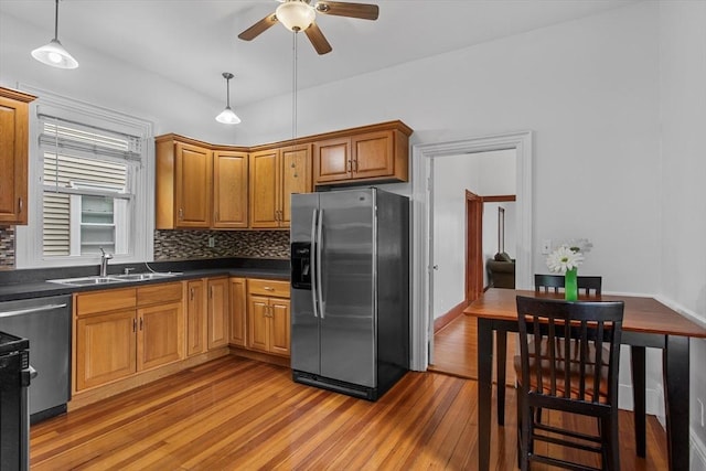 38 Torrey St, Boston, MA 02124 - kitchen featuring appliances with stainless steel finishes, a sink, light wood-style flooring, a ceiling fan, and dark countertops