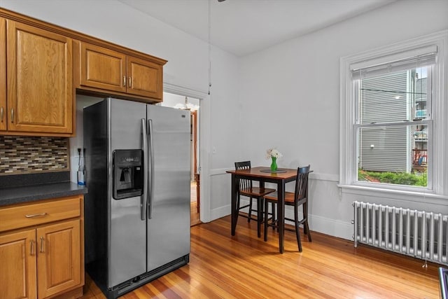 38 Torrey St, Boston, MA 02124 - kitchen with stainless steel fridge with ice dispenser, radiator heating unit, light wood-style floors, dark countertops, and brown cabinets
