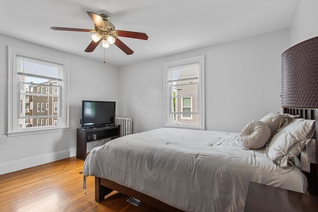 38 Torrey St, Boston, MA 02124 - bedroom with radiator heating unit, multiple windows, wood finished floors, and baseboards