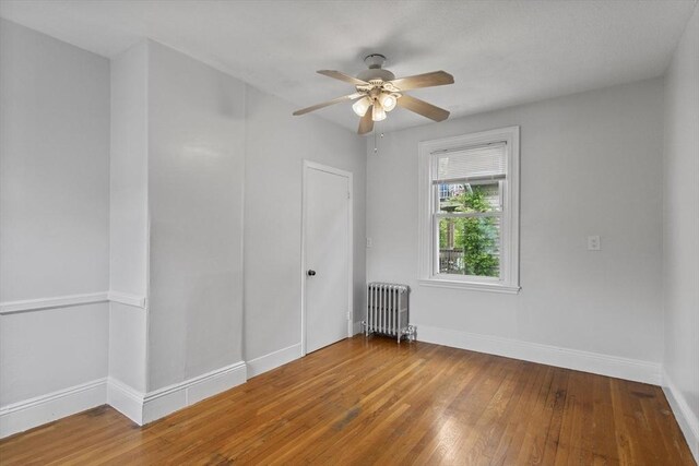 38 Torrey St, Boston, MA 02124 - spare room with radiator, a ceiling fan, baseboards, and hardwood / wood-style flooring