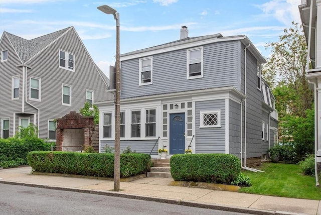 38 Torrey St, Boston, MA 02124 - view of front of house with a chimney and a front yard