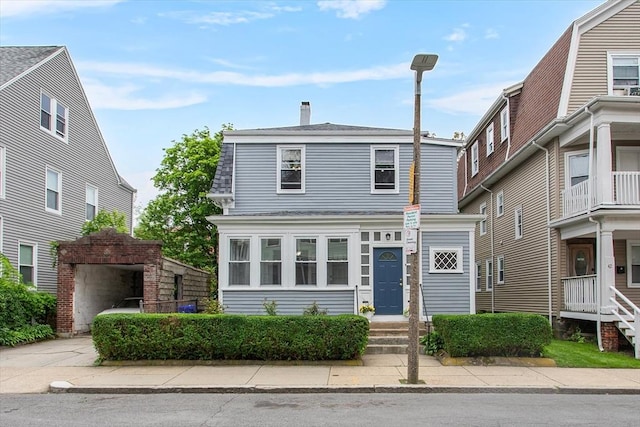 38 Torrey St, Boston, MA 02124 - view of front of property with a chimney, roof with shingles, and a garage
