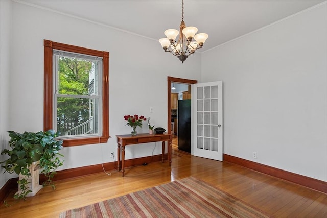 38 Torrey St, Boston, MA 02124 - spare room with wood finished floors, a chandelier, baseboards, and ornamental molding