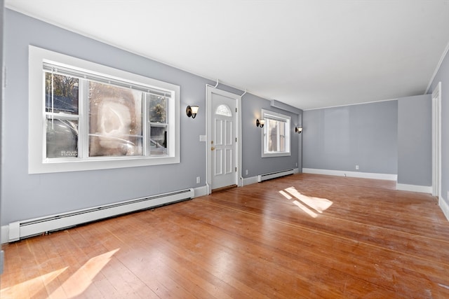 interior space with baseboard heating and hardwood / wood-style flooring