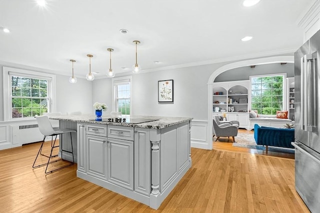 4 Worthen Rd, Winchester, MA 01890 - kitchen with black electric cooktop, ornamental molding, gray cabinets, light wood-style floors, and healthy amount of natural light