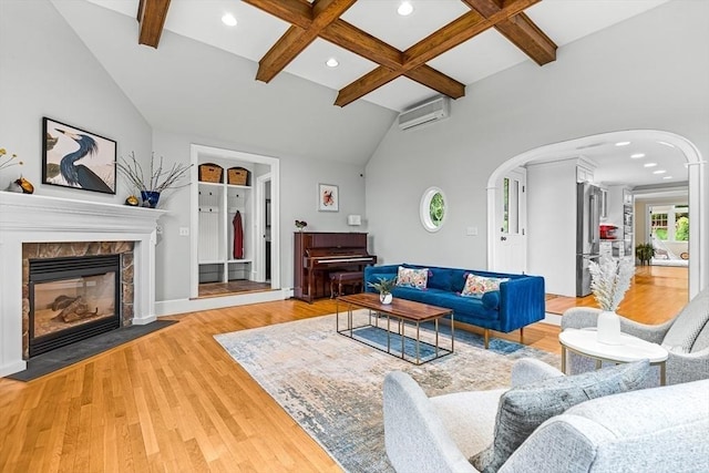 4 Worthen Rd, Winchester, MA 01890 - living room with arched walkways, a wall unit AC, light wood-style flooring, a glass covered fireplace, and coffered ceiling