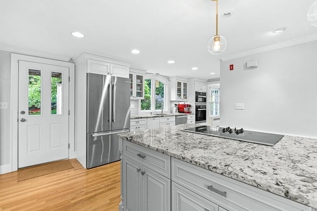 4 Worthen Rd, Winchester, MA 01890 - kitchen featuring stainless steel appliances, ornamental molding, white cabinetry, a sink, and glass insert cabinets