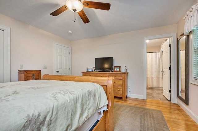bedroom with light wood-type flooring, baseboards, and a ceiling fan