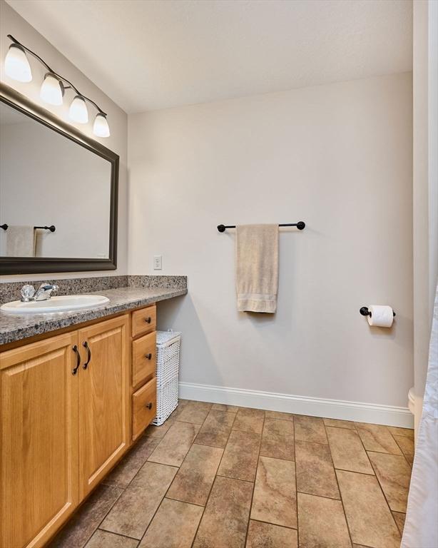 bathroom featuring baseboards, vanity, and tile patterned floors