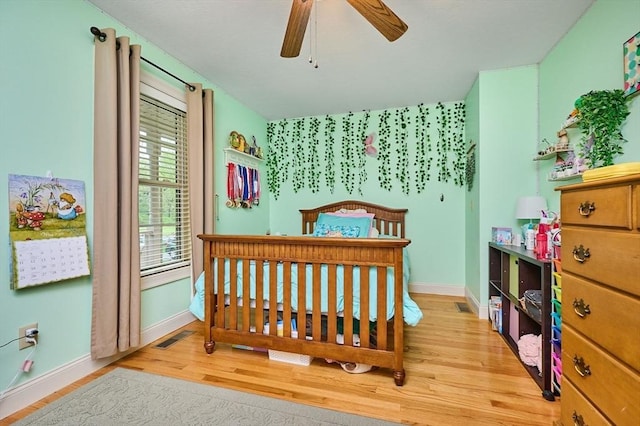 bedroom featuring wood finished floors and baseboards