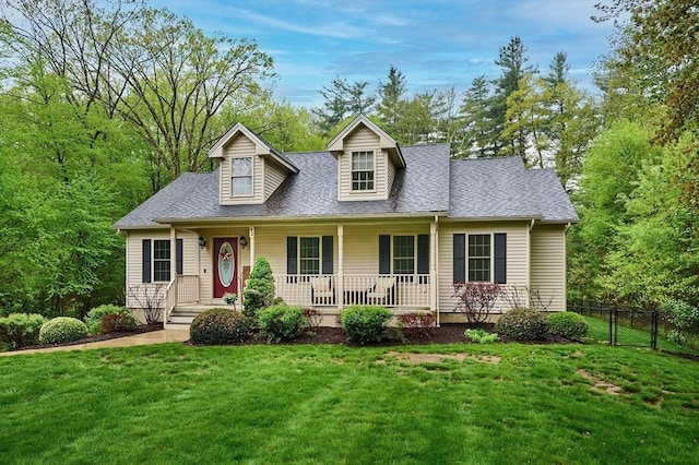 cape cod house featuring a shingled roof and a porch