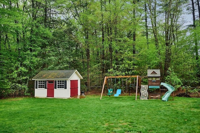 view of shed featuring a playground and a view of trees