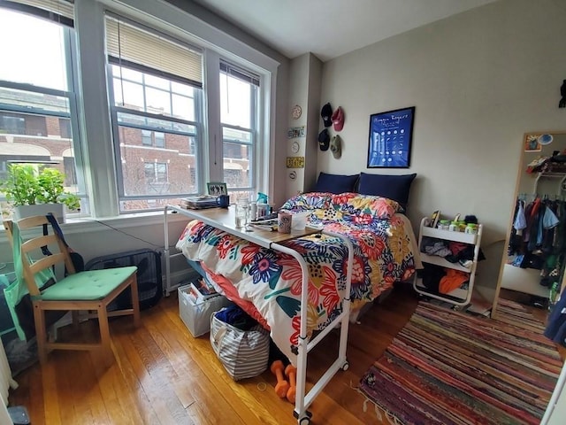 bedroom featuring multiple windows and wood-type flooring