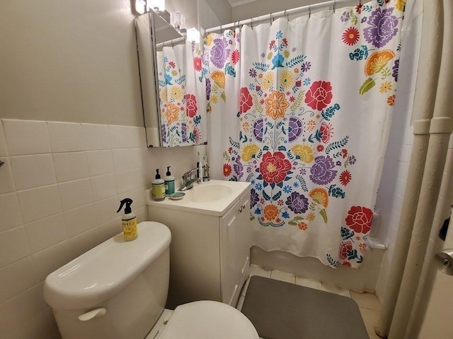 full bath with vanity, tile walls, shower / tub combo, and toilet