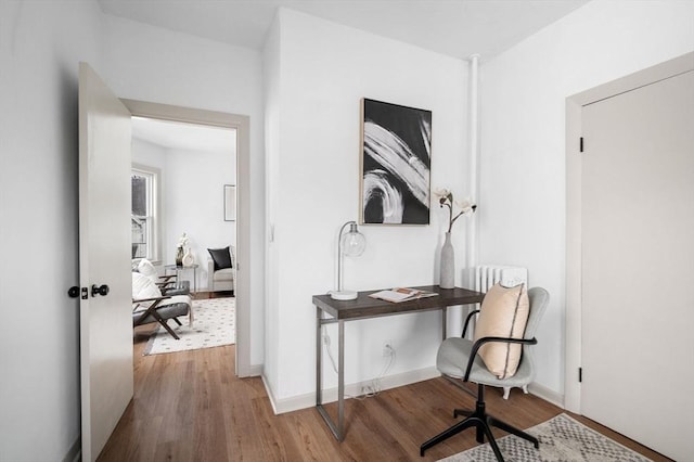 home office featuring wood finished floors and baseboards