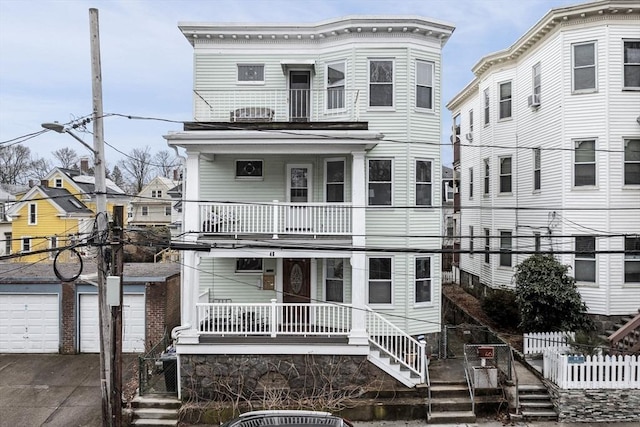 view of front of house featuring a porch, stairs, and a balcony