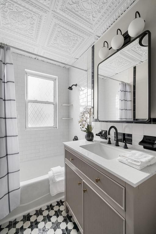 bathroom with shower / tub combo with curtain, an ornate ceiling, tasteful backsplash, tile walls, and vanity