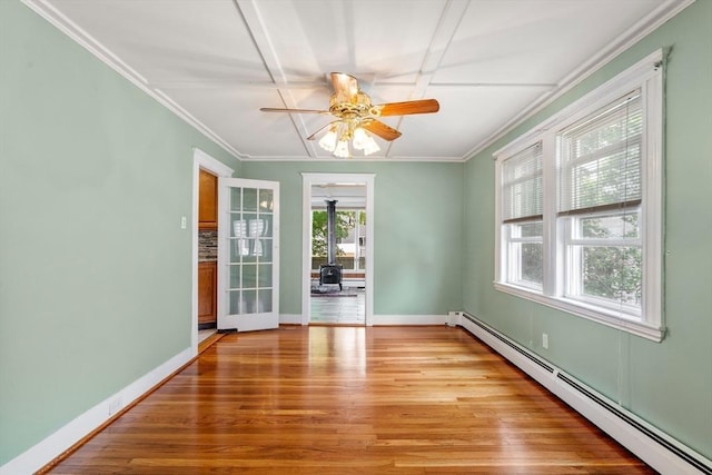 7 Coolidge Rd, Danvers, MA 01923 - empty room featuring baseboard heating, ceiling fan, light wood finished floors, ornamental molding, and baseboards