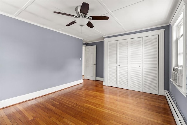 7 Coolidge Rd, Danvers, MA 01923 - unfurnished bedroom featuring a baseboard heating unit, light wood-style floors, baseboards, a closet, and a ceiling fan