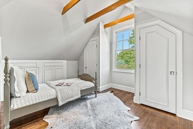 bedroom with dark wood-style flooring, lofted ceiling with beams, and baseboards