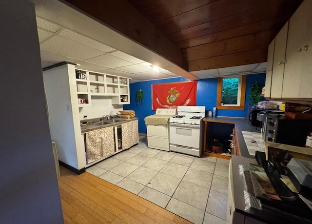 18 Laurel Ave, Sterling, MA 01564 - kitchen featuring white gas stove, washer / dryer, a sink, and open shelves