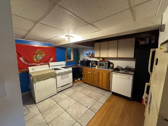 18 Laurel Ave, Sterling, MA 01564 - kitchen featuring white appliances, washer / dryer, a drop ceiling, and brown cabinets