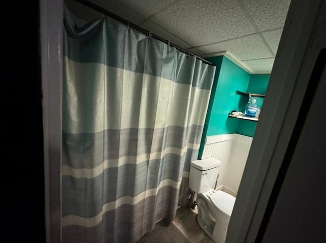18 Laurel Ave, Sterling, MA 01564 - bathroom with toilet, a drop ceiling, wood finished floors, a wainscoted wall, and a shower with shower curtain