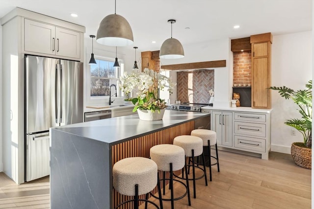 kitchen with tasteful backsplash, a center island, a kitchen bar, light wood-style flooring, and appliances with stainless steel finishes