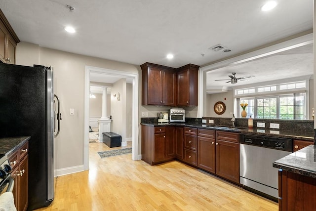 kitchen with sink, light hardwood / wood-style flooring, ceiling fan, appliances with stainless steel finishes, and ornate columns