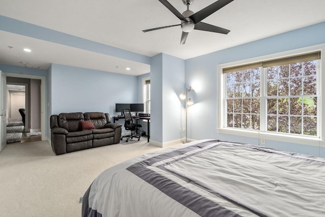 bedroom with ceiling fan and light colored carpet