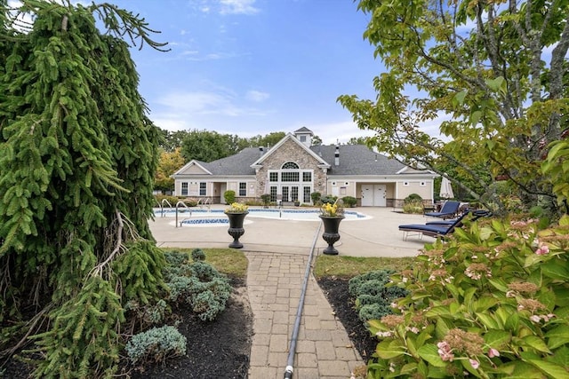 rear view of property featuring french doors and a patio area