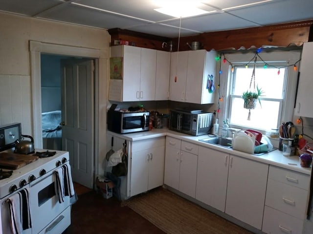 13 William St, Westfield, MA 01085 - kitchen with white gas range oven, stainless steel microwave, and light countertops