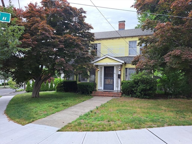 281 Elmwood Ave, Quincy, MA 02170 - view of front facade with a front yard and a chimney