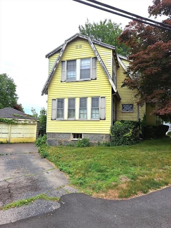 281 Elmwood Ave, Quincy, MA 02170 - view of property exterior with a lawn, a garage, and a gambrel roof