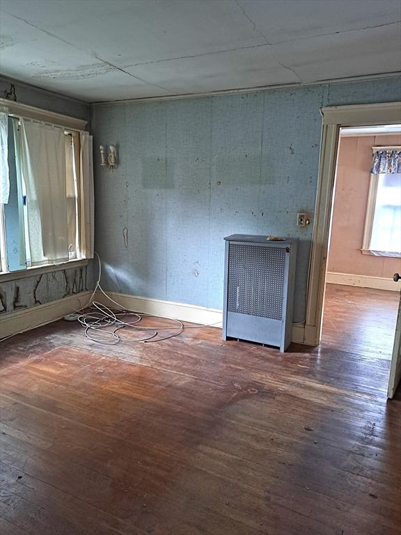 281 Elmwood Ave, Quincy, MA 02170 - empty room with wood-type flooring and radiator heating unit