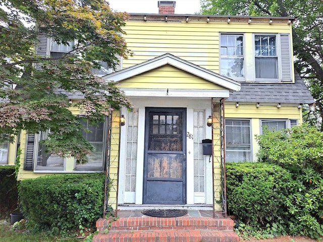 281 Elmwood Ave, Quincy, MA 02170 - property entrance featuring a chimney and roof with shingles