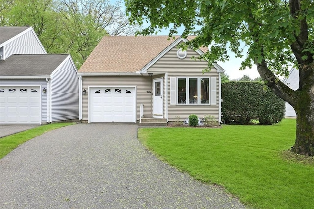 single story home featuring a garage, asphalt driveway, and a front yard