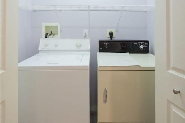 clothes washing area featuring independent washer and dryer