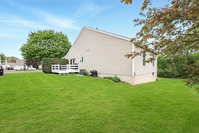 back of property featuring central AC unit, a yard, and a deck