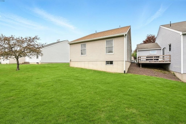 back of house with a yard and a deck