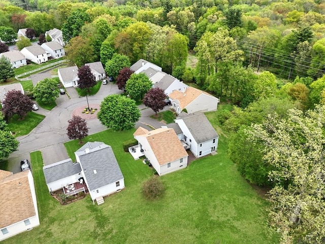 aerial perspective of suburban area featuring a heavily wooded area