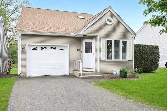 view of front facade with an attached garage, asphalt driveway, a front lawn, and roof with shingles