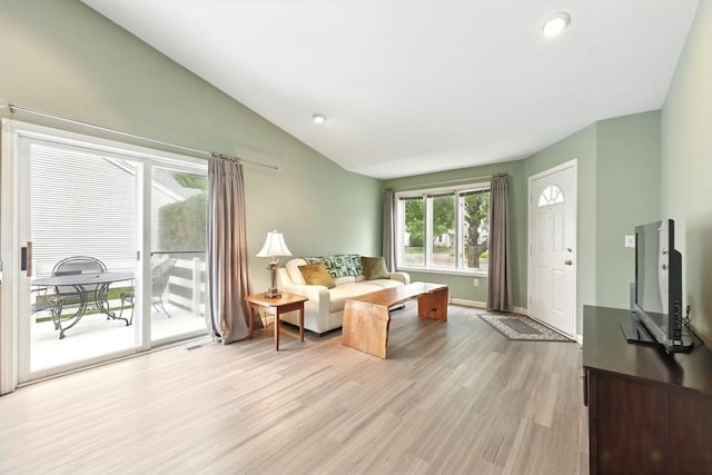 living area with light wood-style flooring, lofted ceiling, baseboards, and recessed lighting