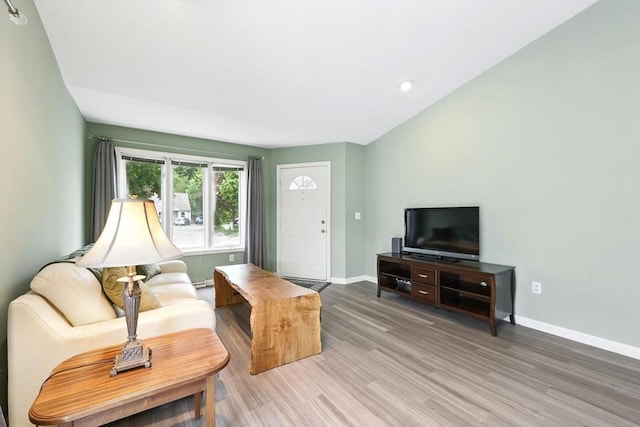 living room with baseboards, light wood-style floors, and recessed lighting