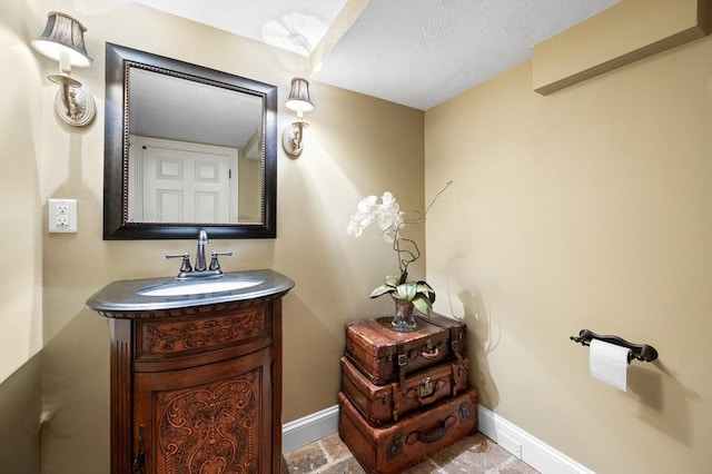 bathroom featuring vanity and baseboards