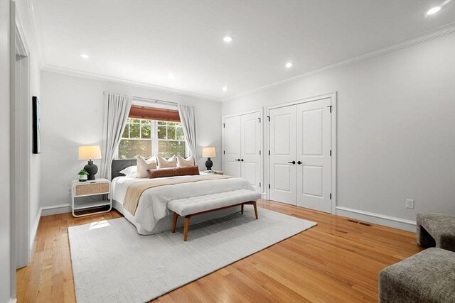 42 Coolidge St Unit 42, Brookline, MA 02446 - bedroom featuring multiple closets, crown molding, light wood-type flooring, baseboards, and recessed lighting