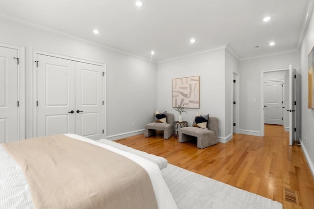 42 Coolidge St Unit 42, Brookline, MA 02446 - bedroom featuring light wood-style floors, recessed lighting, ornamental molding, baseboards, and multiple closets